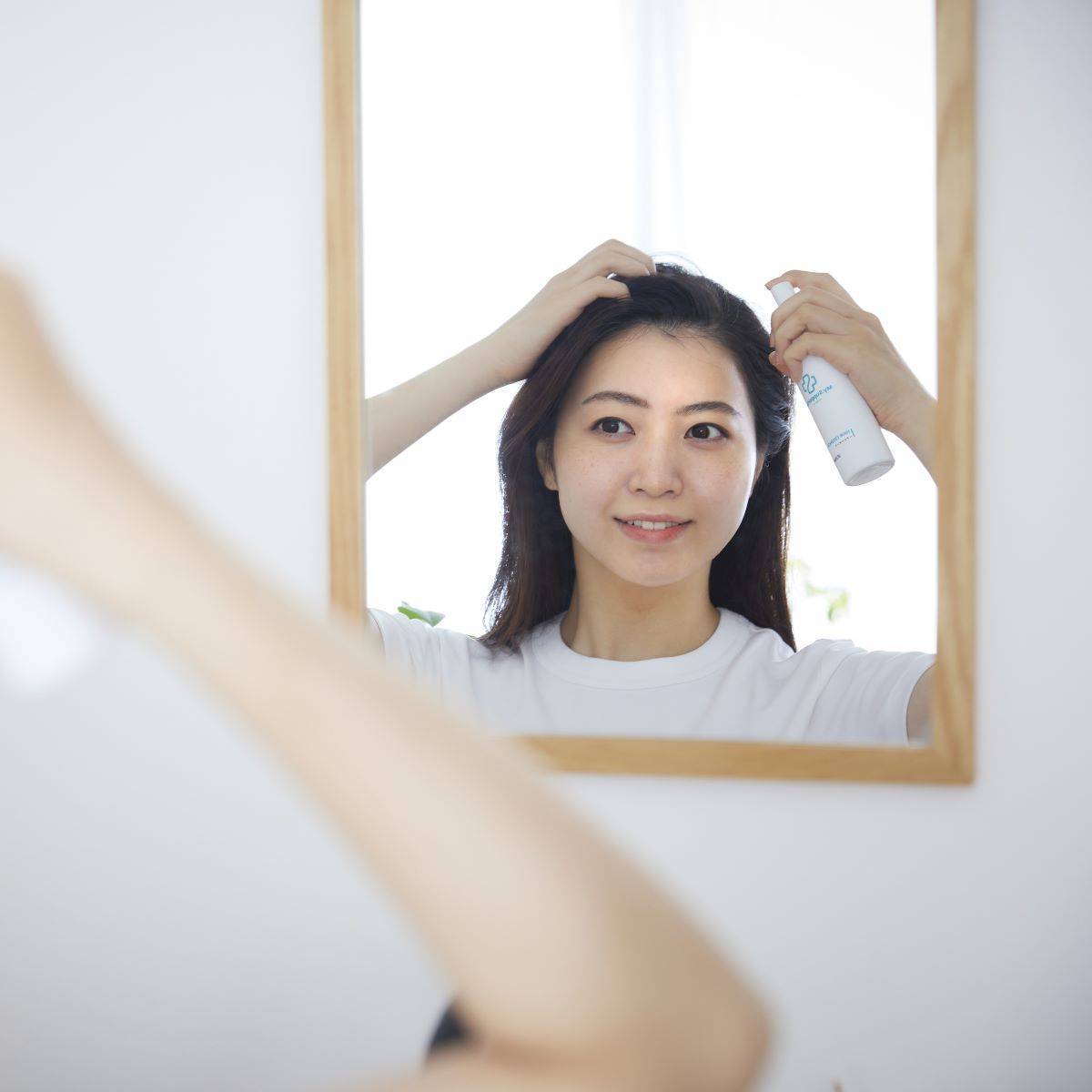 My.Supporter ヘアエッセンスを使用する女性。温泉由来のミネラルIFMC.配合で、頭皮にうるおいを与え健やかな髪へ導く美容ヘアケア製品。